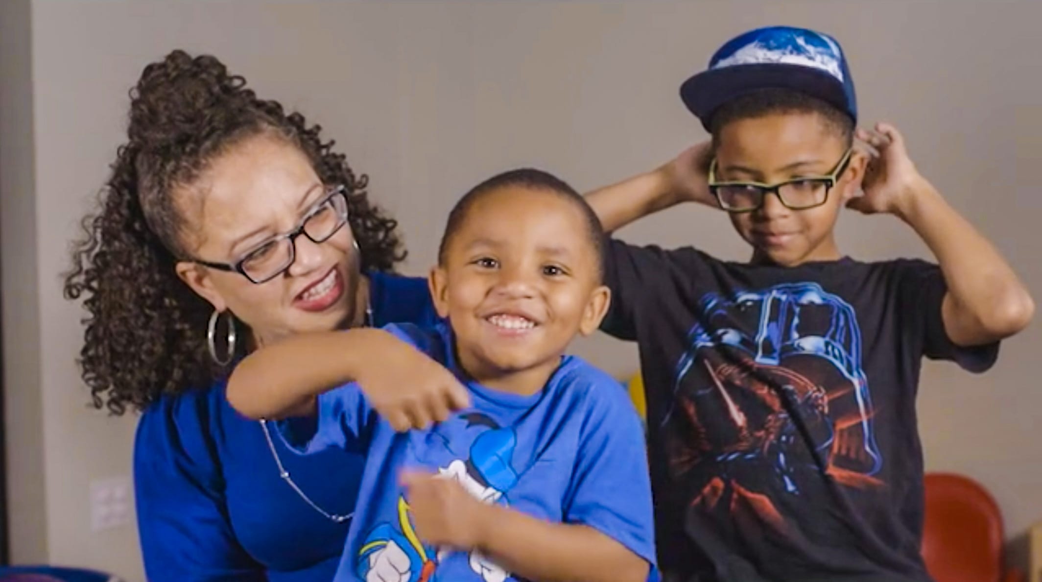 A mother smiling with her two sons.